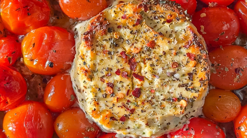 Baked feta cheese with roasted cherry tomatoes, herbs, and chili flakes.