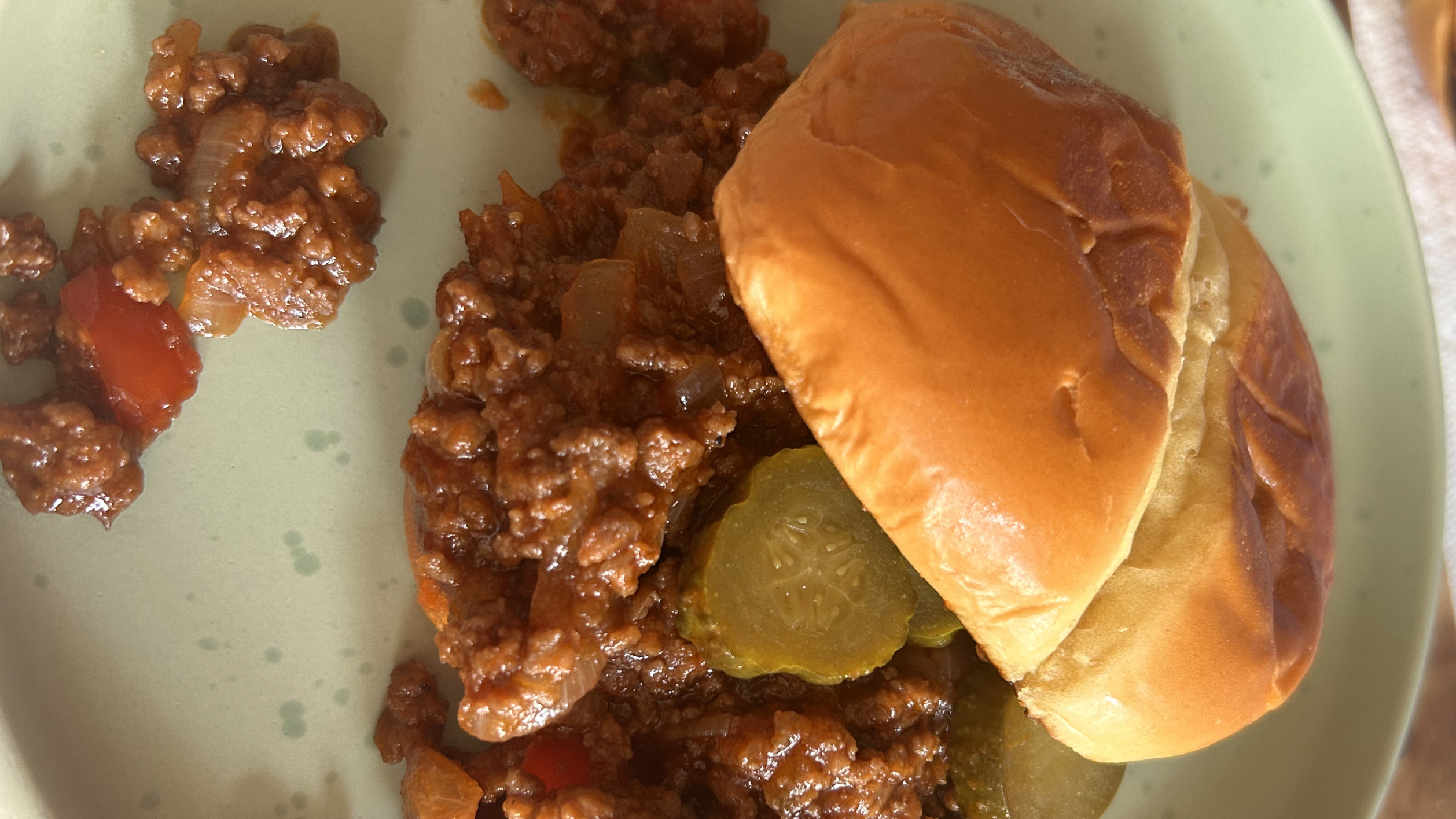 Gopuff sloppy joe sandwich with pickles on a bun. Order hot meals now!