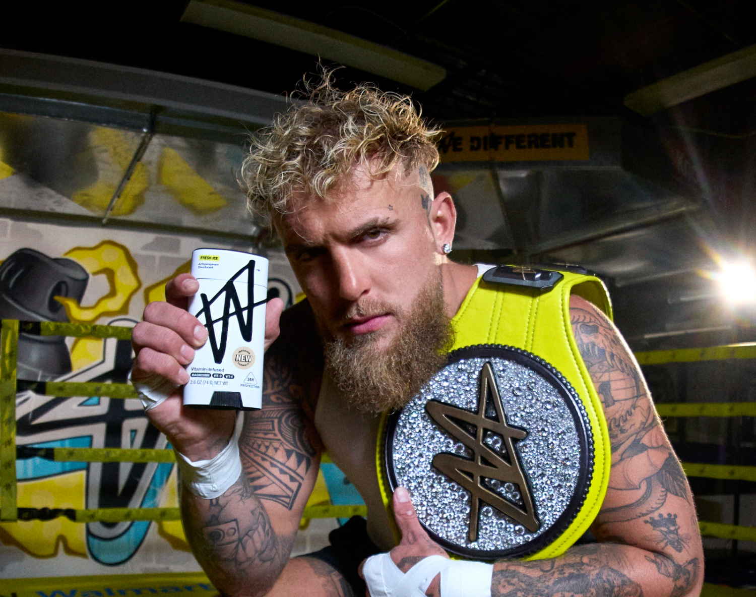 Jake Paul holding W Fresh Ice antiperspirant deodorant in a boxing ring.