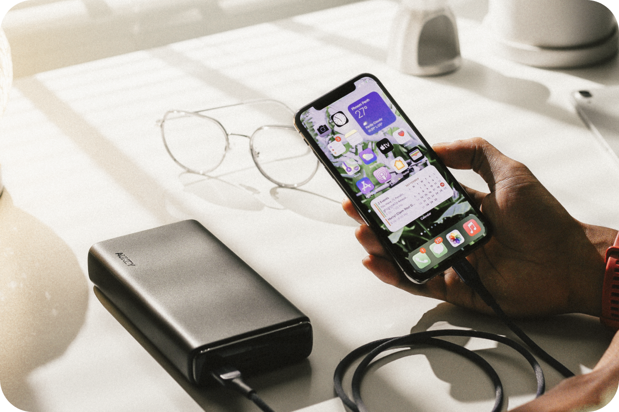A focused DJ, wearing a Carhartt-style jacket over a white t-shirt and headphones, works intently on the turntables and mixer in a dimly lit club, captured with a grainy, 90's digital camera effect