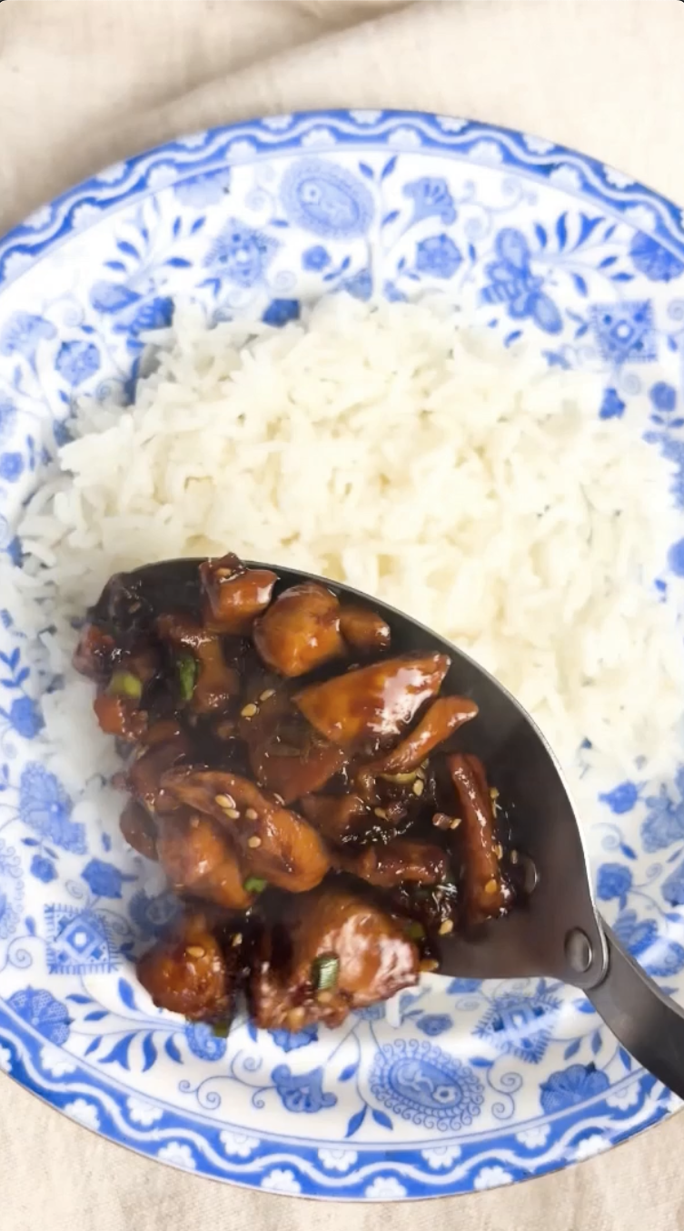 Gopuff glazed chicken and rice meal on a blue plate.