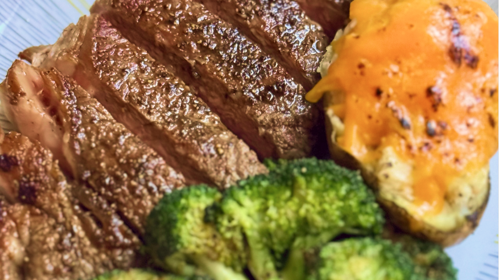 Gopuff meal with sliced steak, cheesy baked potato, and broccoli. Order now!