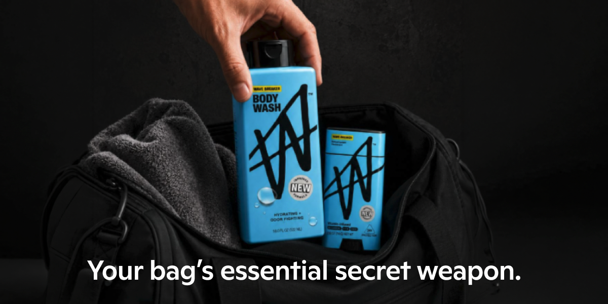 Hand placing W Wave Breaker body wash and deodorant into a black gym bag, reading: Your bag's essential secret weapon.