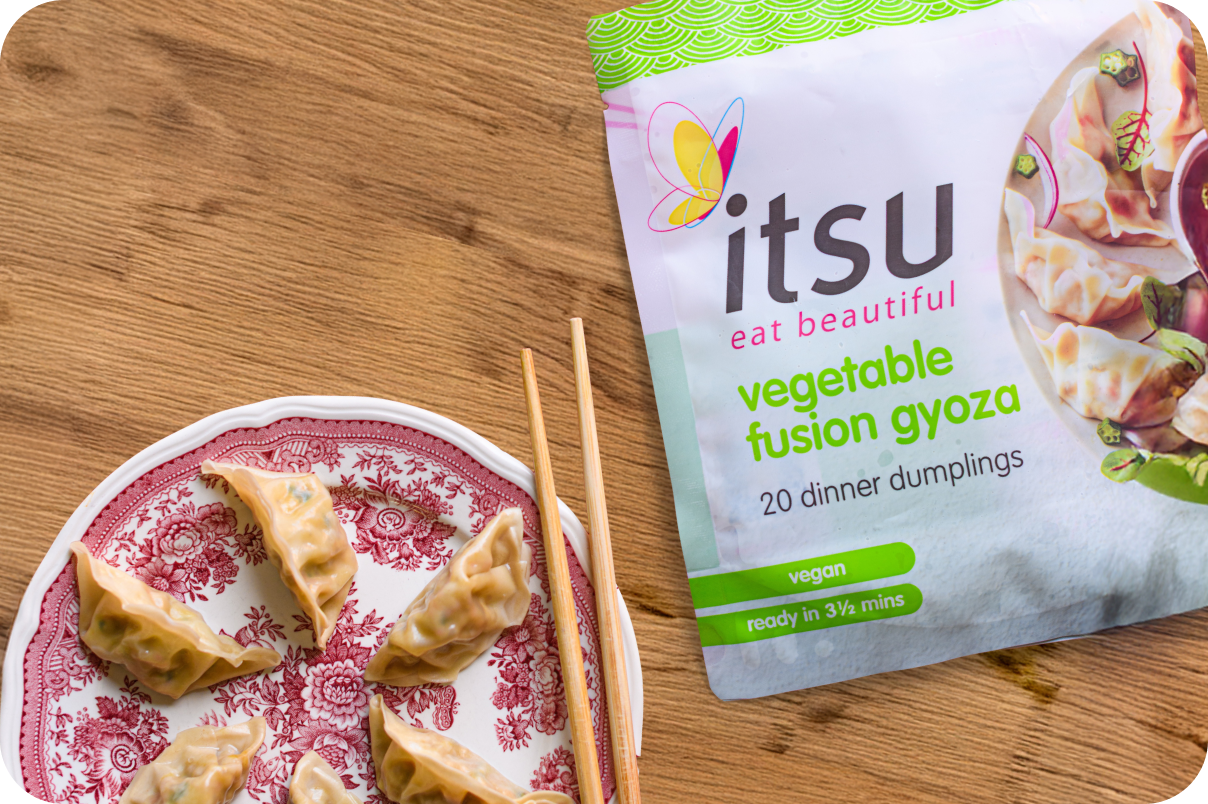 Itsu packet of gyozas on a table with chopsticks