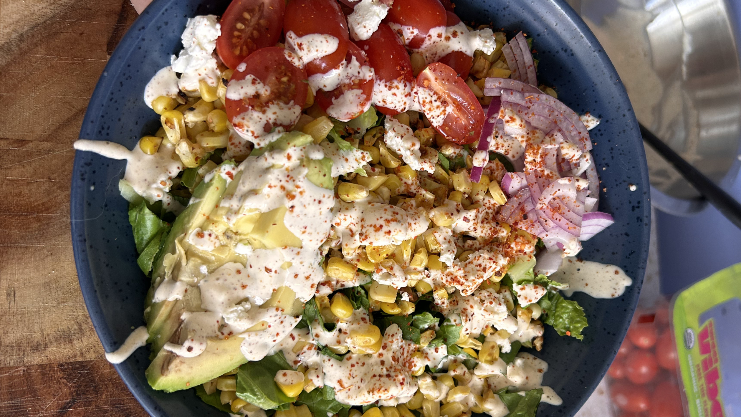 Gopuff fresh salad with avocado, tomatoes, corn, red onion, feta, and creamy dressing. Order fresh food now!
