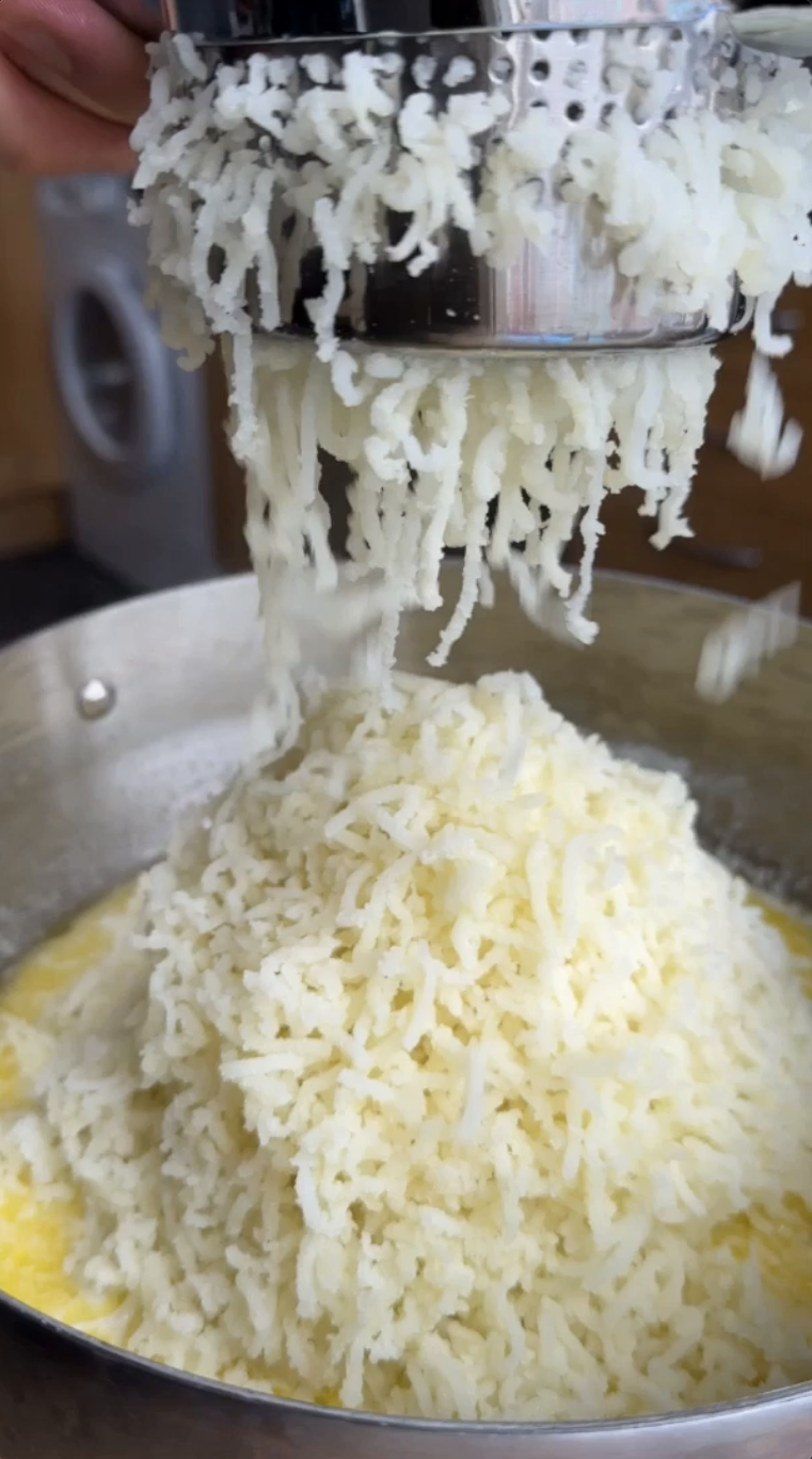 Potato ricer pressing cooked potatoes into a bowl for fluffy mashed potatoes. Get ingredients on Gopuff.