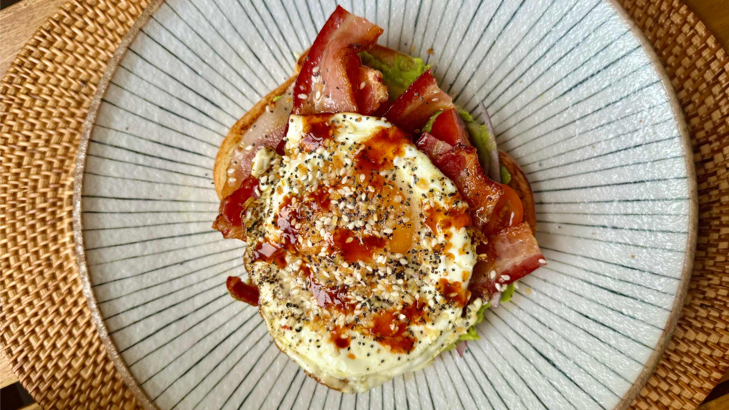 Gopuff breakfast sandwich: fried egg, crispy bacon, avocado, tomato, everything bagel seasoning.